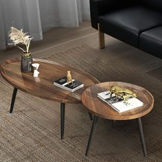 a living room with two black couches and a coffee table in the middle on carpeted flooring