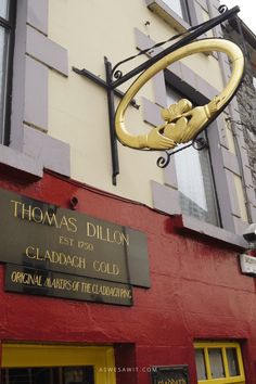 there is a sign on the building that says thomas dilon and gladdah cold