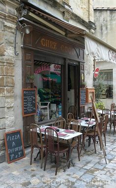 tables and chairs in front of a restaurant