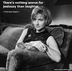 a woman sitting on top of a couch next to a glass bowl in her lap