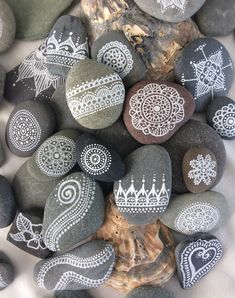 some rocks with white designs on them