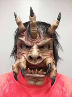 a man with horns and claws on his face