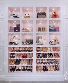 an organized closet with shoes and handbags on the shelves in front of white cabinets