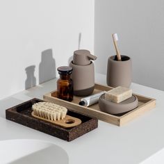 the bathroom accessories are arranged neatly on the counter, including soap and toothbrushes