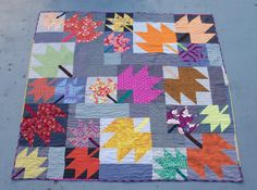 a patchwork quilt with colorful leaves on it