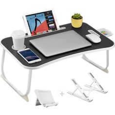 a computer desk with a laptop, tablet and phone on it next to other accessories