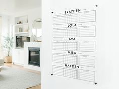 a living room filled with furniture and a white wall mounted to the side of it