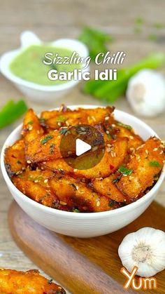 garlic idli served in a white bowl on a wooden platter