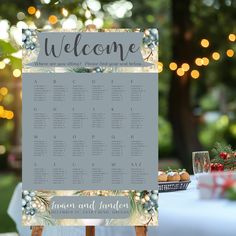 a welcome sign sitting on top of a wooden easel in front of a table