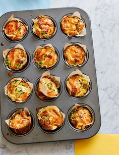 a muffin tin filled with lots of different types of food