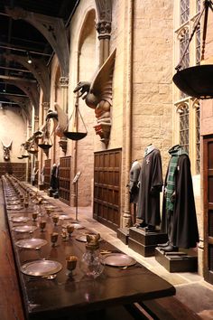 a long table with many items on it in a room filled with wooden tables and chairs