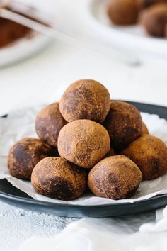 a pile of chocolate truffles sitting on top of a plate