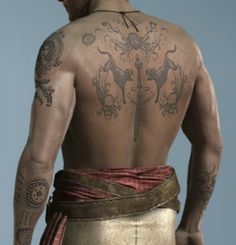 the back of a man with tattoos on his body