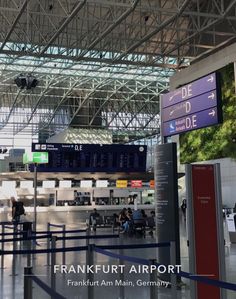 an airport terminal with people sitting at their desks and waiting for their luggage to arrive