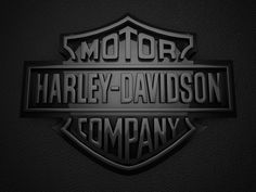 the harley davidson company logo is shown in black and silver on a dark background,