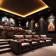 a home theater with two recliners and three movie posters on the wall above them