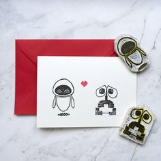 a card with two cartoon characters on it next to a pair of rubber stampers