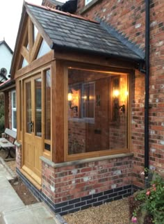 a small brick building with a wooden door and windows