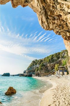 the beach is next to an ocean cave