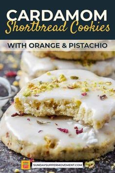 orange and pistachio shortbread cookies with white icing on top are shown