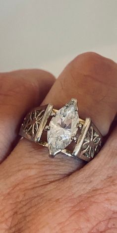 a close up of a person's hand with a ring on it