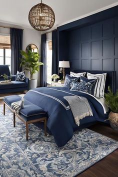 a bedroom with blue and white decor in shades of navy, gray, and gold