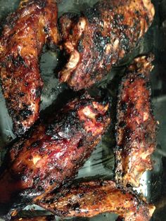 grilled chicken wings sitting on top of a grill