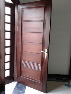 an open wooden door sitting inside of a room