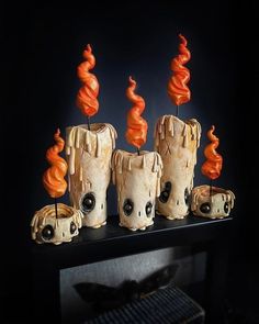 there are some candles that have been made to look like they're coming out of the woods