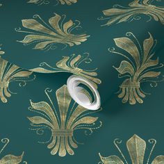 a green and gold wallpaper with an ornate design on it's side,