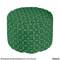 a green and black ottoman cover with leaves on the top, sitting in front of a white background