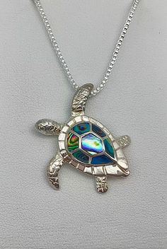 ".925 Solid Sterling Silver Hawaiian Unisex AWESOME Sea Turtle Honu Necklace. The size is LARGER at 32MM, about 1.3\". FREE Italian Sterling Box Chain is Included in your choice of length. This labor-intensive design is just stunning in person.  --In Hawaiian culture Abalone is believed to bring tranquility to the wearer and have healing qualities. The colors of each shell will vary slightly but we try to choose the brightest shells. --The Hawaiian Sea Turtle or \"Honu\" is the only indigenous reptile in the Islands. Symbols of the Turtle are often exchanged to signify strength, longevity and good luck. It is also said to be the Navigator who can always find its way home. --Packaged ready for gifting with a gift box, pouch, Sterling care instructions and a Hawaiian Honu story.  Live Aloha" Turtle Sanctuary, Hawaiian Sea Turtle, Hawaiian Necklace, Collars Diy, Turtle Jewelry, Green Sea Turtle, Hawaiian Culture, Box Pouch, Turtle Art