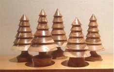 several small wooden christmas trees sitting on top of a table