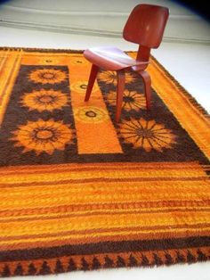 an orange and brown rug with a chair on it