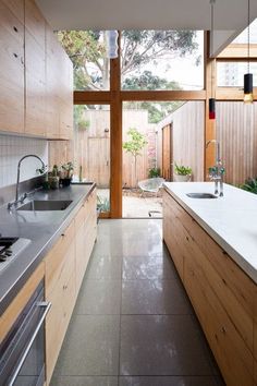 a kitchen with wooden cabinets and white counter tops