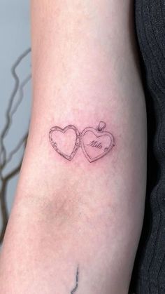 two hearts tattoo on the arm