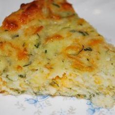 a slice of quiche with cheese and herbs on it