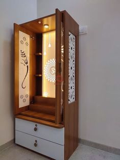 an open cabinet with drawers and lights inside