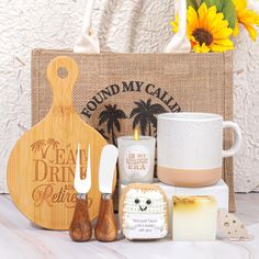 a wooden cutting board sitting on top of a table next to a mug and other items