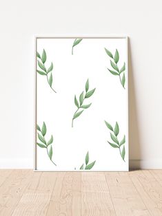 a green leafy pattern on a white background is displayed in an empty room with wood flooring