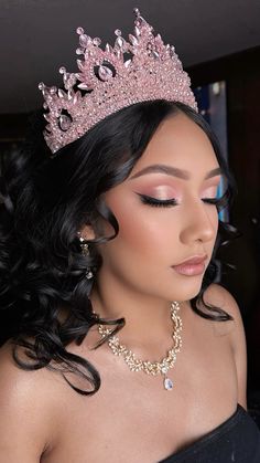 a woman wearing a tiara and jewelry