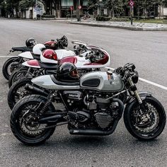 several motorcycles are parked in a row on the street