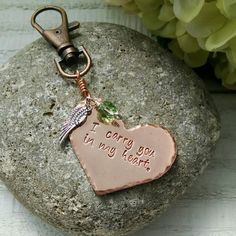 a heart shaped keychain that says i carry you in my heart