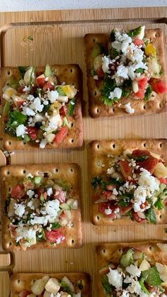 several square trays filled with different types of food