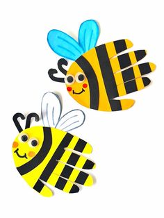 two paper bees with faces on them, one is yellow and the other is black