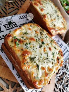 two slices of pizza sitting on top of a wooden cutting board