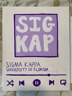 a sign that reads sigma kapp university of florida on the side of a bed