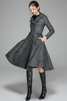 "Add a touch of style to your outfits with this fit and flare gray swing coat. This flattering shape is a chic cut that suits everyone. You'll find that you'll be wearing this versatile coat again and again. The fit and flare coat is the ultimate in luxury women's outerwear and a real statement piece. The pleating at the front adds structure whilst the cinched in waist and full skirt gives a feminine look. The gray monochrome palette can be paired with your existing winter wardrobe easily and yo Gray Long Pea Coat For Winter, Fitted Gray Wool Coat For Fall, Fitted Gray Pea Coat For Winter, Fitted Gray Winter Pea Coat, Gray Fitted Winter Pea Coat, Elegant Gray Wool Coat With Buttons, Gray Double-breasted Wool Coat For Fall, Chic A-line Wool Coat For Fall, Chic Gray Wool Coat For Fall