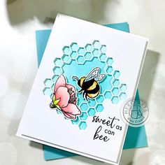 a close up of a card with a bee and flower on the inside of it