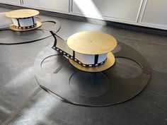 three round tables with circular bases on the floor